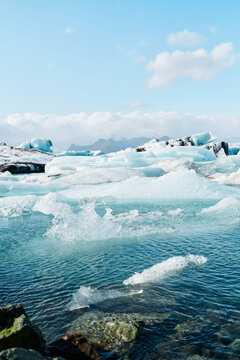 Melting blue icebergs floating in clear arctic water
