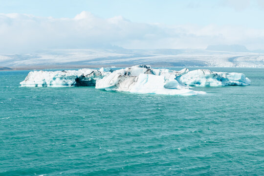 Large icebergs float in a glacier lagoon in the icy waters of Iceland