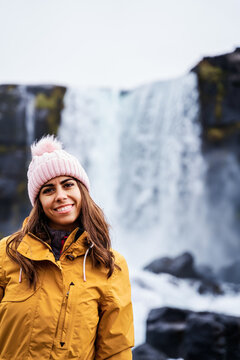 A young white woman wearing winter clothes smiles