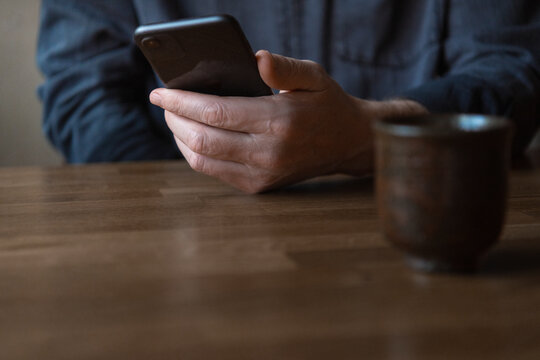 Close-up of senior man holding smartphone
