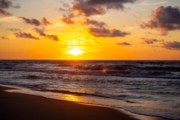 Obraz premium Sunset on the beach, waves, sea, summer.
