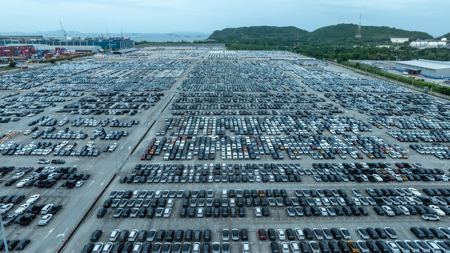 This EV car awaits shipping. Each EV car gets loaded. The EV car goes overseas.