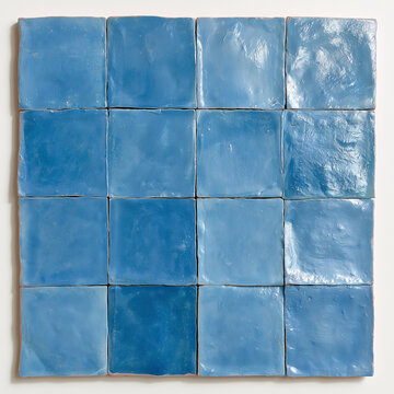 Deep blue handmade square ceramic tiles arranged in a 4x4 grid, with glossy uneven glaze, irregular edges and authentic handcrafted surface variations.