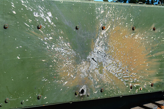 Shrapnel marks and holes on the armor