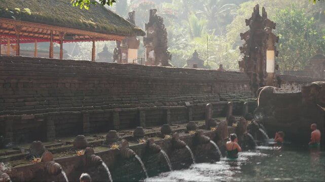 Tirta Empul Temple Bali Indonesia sacred purification ritual with visitors bathing at the holy spring water temple complex
