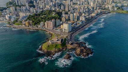 Fototapeta premium Aerial view of Farol da Barra fort and rocky shoreline