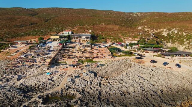Aerial drone view of porto limnionas, a rocky cove with a tavern and beach club in zakynthos