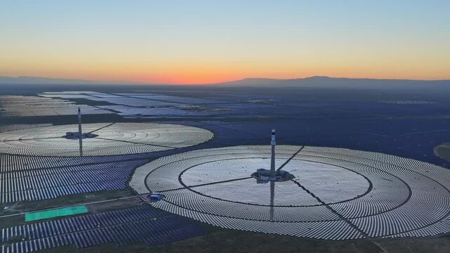Molten salt tower solar thermal power plant at sunrise, new energy source, super mirror power plant, prism tower