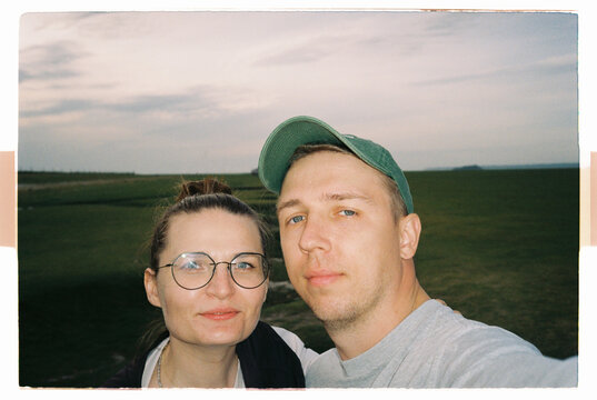 Couple portrait at sunset with countryside background
