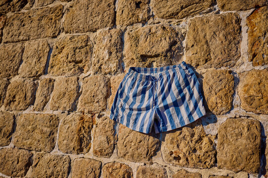 Shorts drying on a Stone Wall