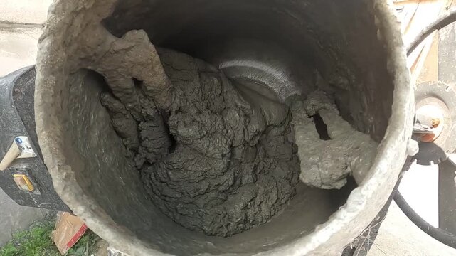 Construction Site Featuring a Concrete Mixer: A Look at the Process of Mixing Fresh Concrete for Building Projects.