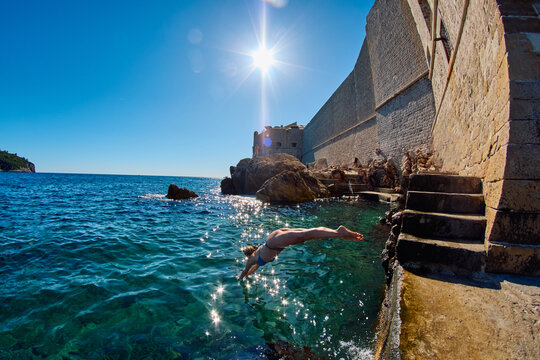 Person jumps Into sea Water