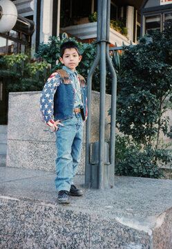 Young boy wearing stars and stripes vest posing
