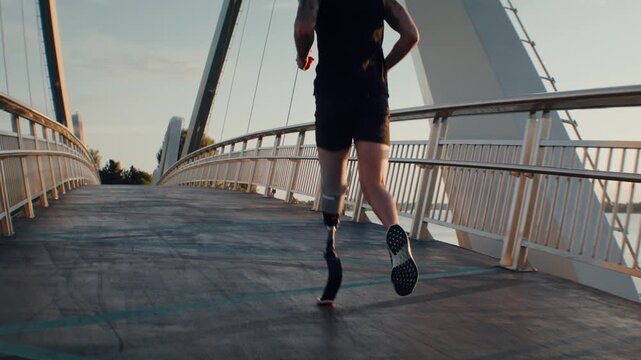Active man with leg prosthesis trains by running on footbridge