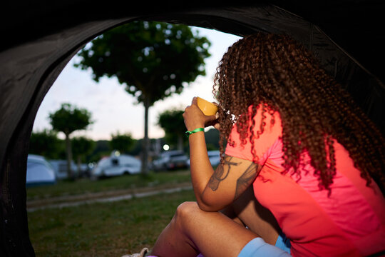 Woman drinking coffee camping at outdoor campsite