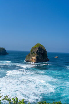 The vast, blue expanse of the sea viewed from atop the cliffs at Tanjung Penyu, Malang.