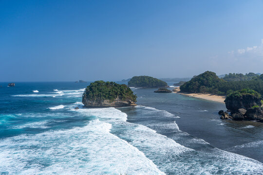 The vast, blue expanse of the sea viewed from atop the cliffs at Tanjung Penyu, Malang.