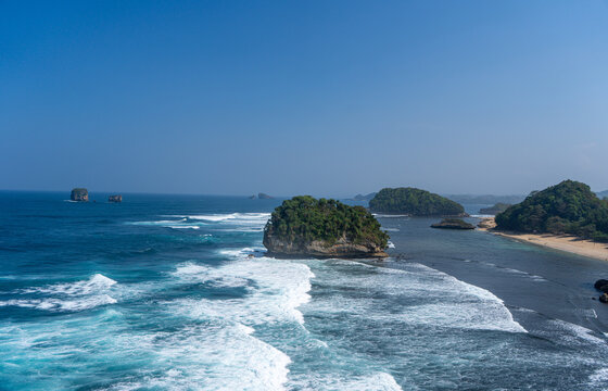 The vast, blue expanse of the sea viewed from atop the cliffs at Tanjung Penyu, Malang.