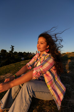 Woman in the park in sunlight with breeze on the hair