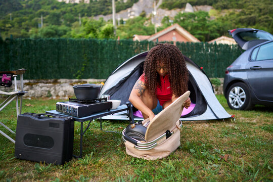Woman preparing to cook at a campsite
