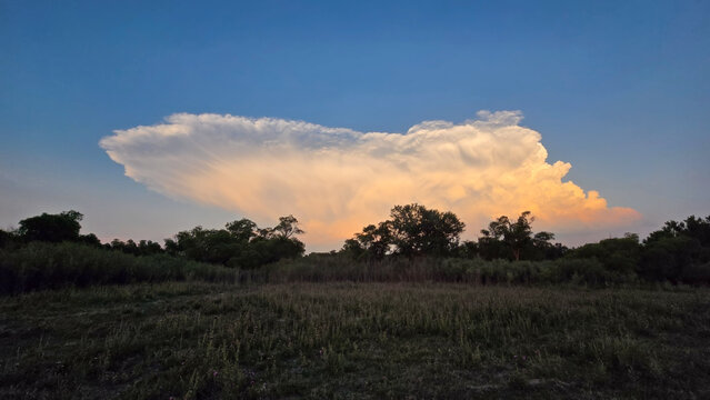 Storm clouds build in the east . Orange color from the sun setting is beautiful and the sky is very blue everywhere else. 