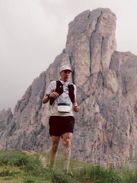 Portrait of a trail athlete during the race across a mountain 