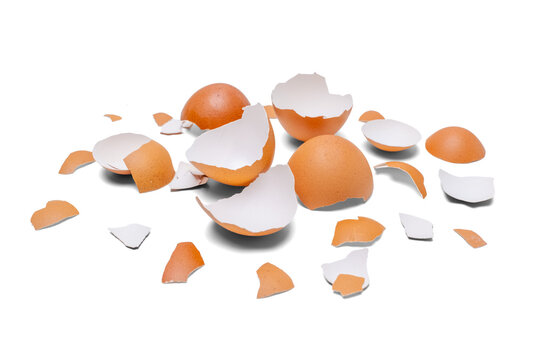 Pile of cracked brown eggshell fragments isolated on clean white background with copy space. Organic kitchen waste, natural calcium source, and baking preparation concept.