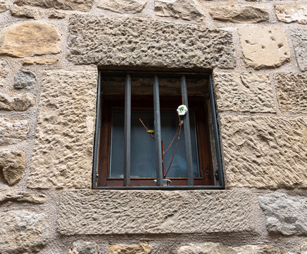 Sos del Rey Catolico, Zaragoza, Spain &ndash; Traditional stone wall and barred window in medieval old town