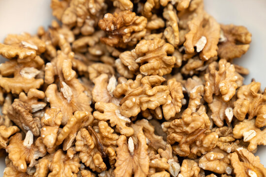 Close up raw organic walnut kernels background rich in healthy omega 3 fatty acids, vegan protein, and essential nutrients, ideal for clean eating, keto diet recipes, snacking, and cooking inspiration