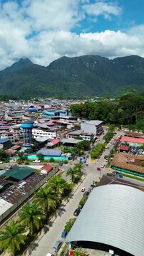 Scenic drone flight over Tingo Maria city with the iconic Sleeping Beauty mountain chain in the background.