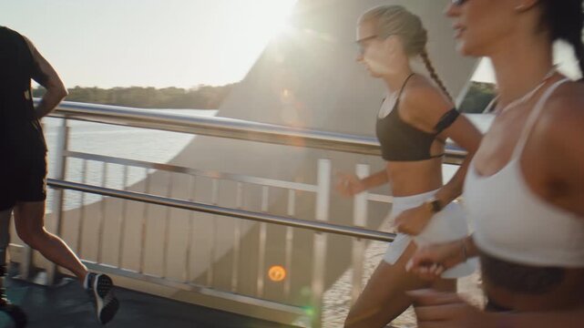 Amputee athlete runs with group along sunny riverside bridge
