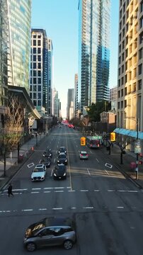 Flight between skyscrapers along the street in Downtown of Vancouver