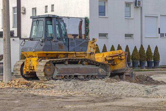 Old Equipment Tracked Bulldozer Machine Moving Sand at Construction Site