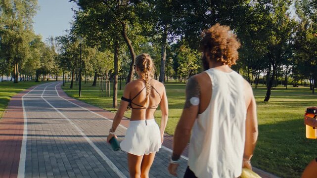 Fitness group walks calmly through park after running session