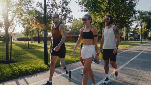 Runners walk together through sunny park after morning workout