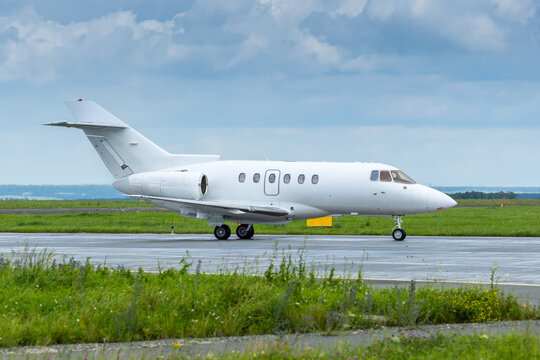 White private jet taxiing an airport taxiway