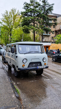 A gray UAZ-452 &ldquo;Buchanka&rdquo; van is parked in downtown Kutaisi; a classic Soviet minibus on the road, Imereti, Georgia 5.4.25