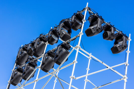 Stage Lighting Fixtures on Metal Scaffolding Under Blue Sky