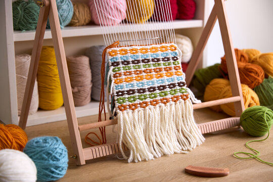 Tapestry weaving wall hanging created with different colors of yarn.