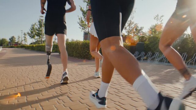 Runners continue group workout with amputee athlete on paved path