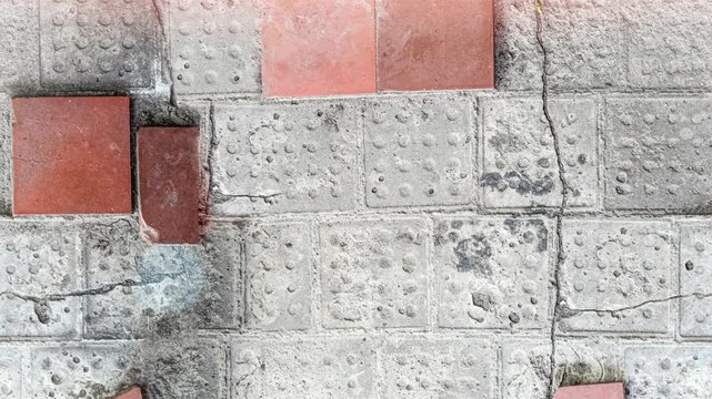 Seamless 4K looping vertical movement across a decorative wall with concrete blocks and red brick accents. Ideal for architectural backgrounds and urban design projects.