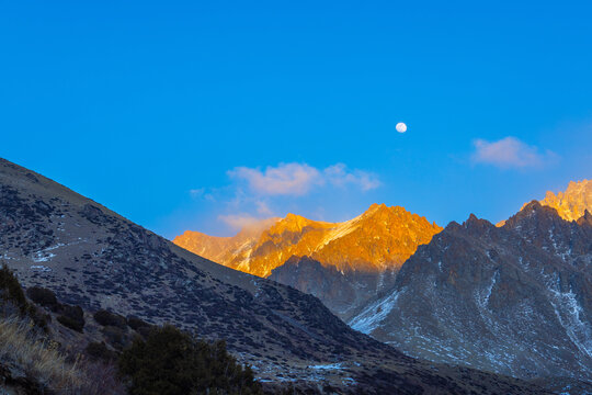 Majestic Mountain Range at Sunset with Full Moon
