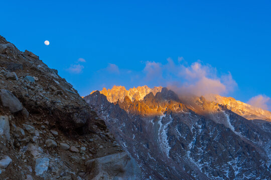 Dramatic Mountain Landscape at Sunrise with Full Moon