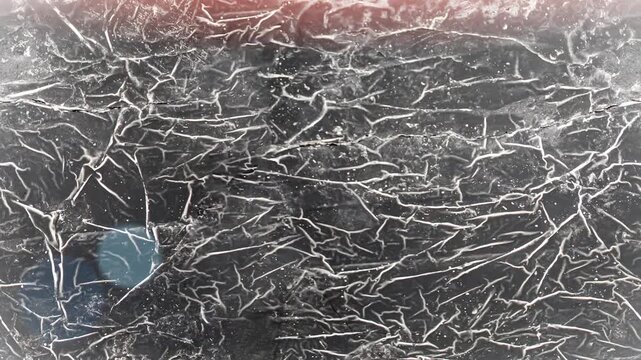 Seamless 4K looping vertical movement across a dark scratched wall texture with dense crack patterns. Perfect for grunge backgrounds industrial visuals and motion graphics.