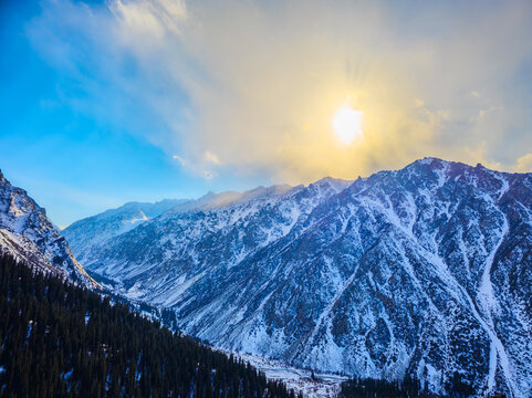 Dramatic Snow-Covered Mountains Under Bright Sunlight
