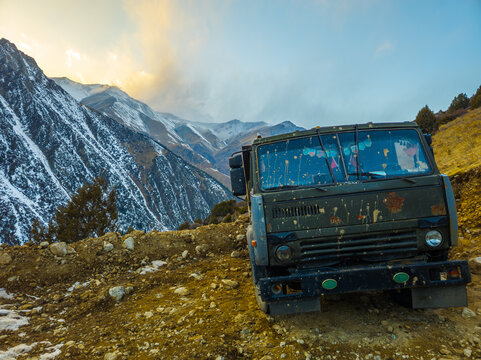 Military truck parked on rocky mountain road in Kyrgyzstan