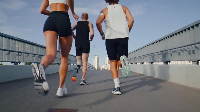 Fitness group runs together across wide pedestrian bridge