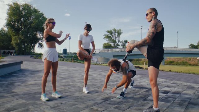 Fitness group performs dynamic warmup before outdoor running
