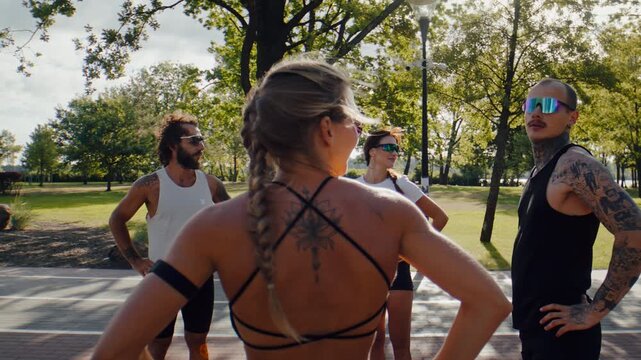 Fitness group loosens neck muscles before running in sunny park