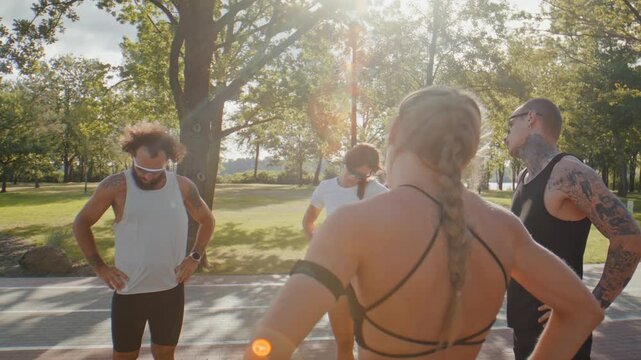 Athletes stretch necks together during pre-run park warmup